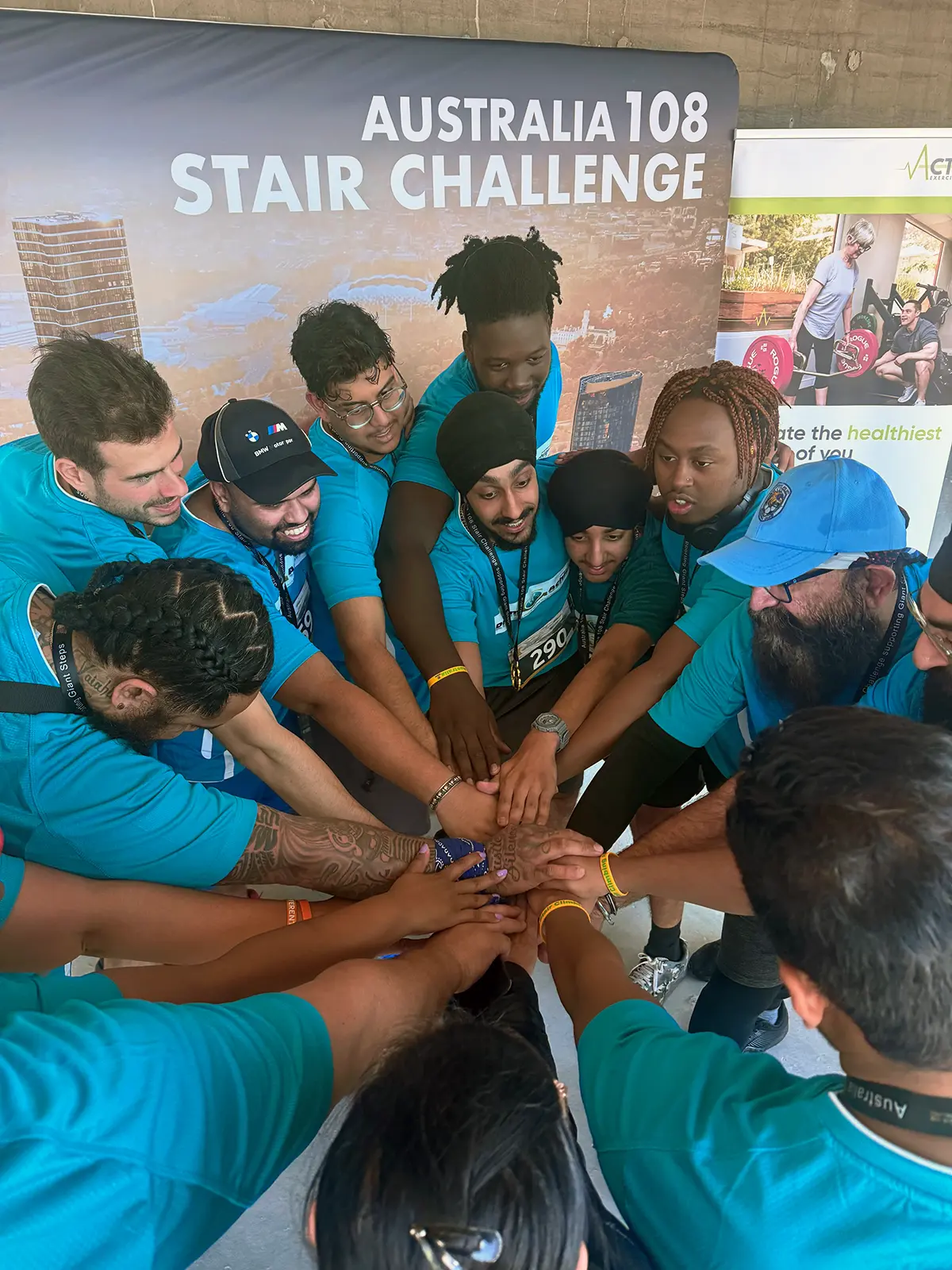 AVP Perminderjit Singh's DreamAchiever Team join hands in a huddle before they climb Australia 108 