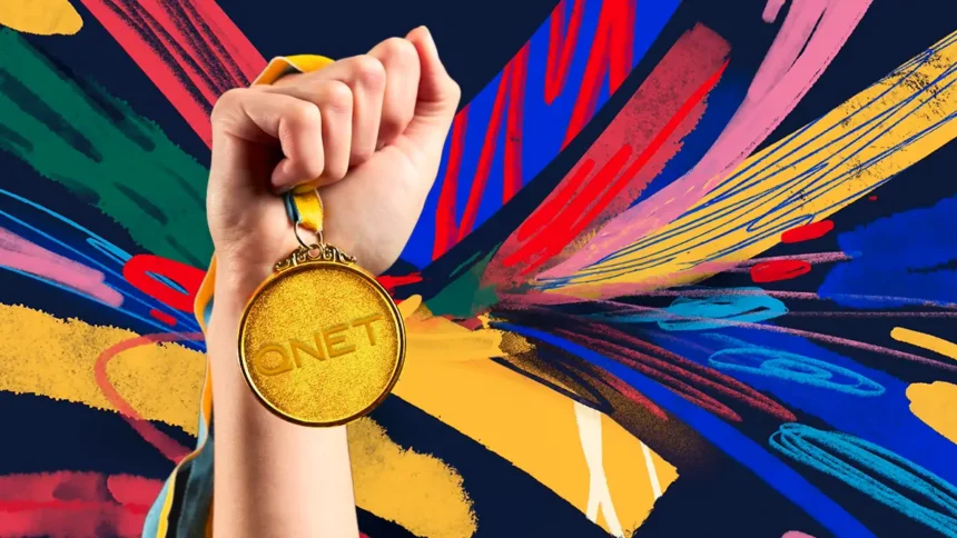 A hand holding a QNET gold medal to symbolize QNET Business Success and how QNET Champions Champions with its services and products