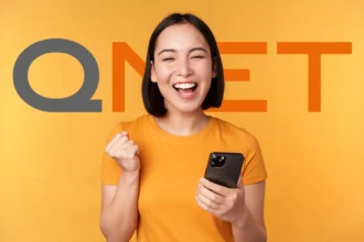 Excited woman holding her phone after a successful QNET Registration